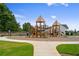 Outdoor playground featuring slides and climbing structures, with manicured grass and wooded backdrop at 739 Marlay Sw Ln, Powder Springs, GA 30127