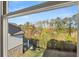 A window view shows lush trees, greenery, and a glimpse of the backyard at 739 Marlay Sw Ln, Powder Springs, GA 30127