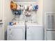 Functional laundry area with washer, dryer, and storage shelves for organization at 91 East Meadow Ln, Conyers, GA 30012