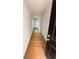 Hallway featuring white walls and a dark door, with flooring covered for protection at 11594 E Lovejoy Rd, Hampton, GA 30228
