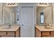 Dual sink vanity bathroom with cream colored cabinets, framed mirrors, and neutral color palette at 2505 Thackery Ct, Cumming, GA 30041
