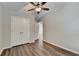 Neutral bedroom featuring hardwood floors, neutral paint, closet and a ceiling fan at 2505 Thackery Ct, Cumming, GA 30041