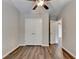 Bedroom featuring a ceiling fan, hardwood floors, and closet at 2505 Thackery Ct, Cumming, GA 30041