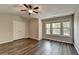 Large bedroom featuring wood floors, a ceiling fan, and a closet with double doors at 2505 Thackery Ct, Cumming, GA 30041