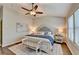 Bedroom with wood floors, vaulted ceiling, ceiling fan, and a plush upholstered bed with bench at 2505 Thackery Ct, Cumming, GA 30041