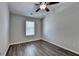A bedroom featuring hardwood floors, neutral paint, a window with blinds and a ceiling fan at 2505 Thackery Ct, Cumming, GA 30041