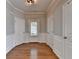 Well-lit foyer features hardwood floors, white trim, and multiple doors for seamless transitions into other rooms at 2505 Thackery Ct, Cumming, GA 30041