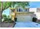 Charming two-story home featuring a stone facade, attached two-car garage, and a well-manicured front yard at 2505 Thackery Ct, Cumming, GA 30041