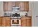 Beautiful kitchen featuring stainless steel appliances, wood cabinets, and granite countertops at 2505 Thackery Ct, Cumming, GA 30041