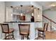 Cozy kitchen features bar seating, pendant lights, and a staircase nearby for convenience and accessibility at 2505 Thackery Ct, Cumming, GA 30041