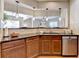 This kitchen features a breakfast bar with pendant lights, dark countertops, and wooden cabinets at 2505 Thackery Ct, Cumming, GA 30041