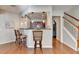 Kitchen with bar seating, pendant lights, and stainless steel appliances is perfect for casual dining and entertaining at 2505 Thackery Ct, Cumming, GA 30041
