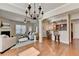 Spacious living area featuring hardwood floors, a modern fireplace, and seamless flow to the kitchen at 2505 Thackery Ct, Cumming, GA 30041