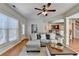 Inviting living room featuring a comfortable sectional, wood floors, and ceiling fan at 2505 Thackery Ct, Cumming, GA 30041