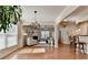 Bright and airy living room with hardwood floors, a modern chandelier, and seamless access to the kitchen at 2505 Thackery Ct, Cumming, GA 30041