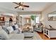 Inviting living room features hardwood floors and neutral décor, seamlessly flowing into the kitchen area at 2505 Thackery Ct, Cumming, GA 30041