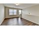 Inviting loft area with hardwood floors, neutral paint, two windows and a half wall at 2505 Thackery Ct, Cumming, GA 30041