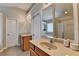 Spacious main bathroom featuring dual vanities, large mirror, and tile floors at 2505 Thackery Ct, Cumming, GA 30041