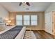 Inviting bedroom with ceiling fan, plush bed, bench, and ample natural light from three windows at 2505 Thackery Ct, Cumming, GA 30041