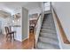 Carpeted staircase leading upstairs with wood railing, and view of kitchen bar at 2505 Thackery Ct, Cumming, GA 30041