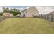 Large backyard with lush green grass, a playset, and a privacy fence at 3868 Sweet Iris Cir, Loganville, GA 30052