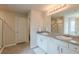Bright bathroom features a double vanity with large mirror and tile flooring at 3868 Sweet Iris Cir, Loganville, GA 30052