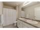Bathroom featuring double vanity sinks, a large mirror, and a shower with a curtain at 3868 Sweet Iris Cir, Loganville, GA 30052