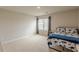 Comfortable bedroom featuring a large window with blinds and plush carpet at 3868 Sweet Iris Cir, Loganville, GA 30052
