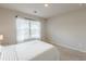 Bedroom featuring a bed next to the window at 3868 Sweet Iris Cir, Loganville, GA 30052