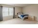 Comfortable bedroom featuring a large window with blinds and plush carpet at 3868 Sweet Iris Cir, Loganville, GA 30052