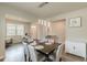 Open concept dining room with decorative lighting and nearby office and front entry at 3868 Sweet Iris Cir, Loganville, GA 30052