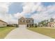 Inviting two-story home featuring a brick facade, well-manicured lawn, and a spacious driveway leading to a two-car garage at 3868 Sweet Iris Cir, Loganville, GA 30052