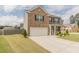 Beautiful two-story home with a well-manicured lawn and a spacious driveway leading to a two-car garage at 3868 Sweet Iris Cir, Loganville, GA 30052
