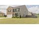 Two-story home with a combination of brick and vinyl siding, featuring a well-maintained lawn and a two-car garage at 3868 Sweet Iris Cir, Loganville, GA 30052