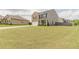 Well-maintained two-story home with a spacious front yard and a long driveway leading to a two-car garage at 3868 Sweet Iris Cir, Loganville, GA 30052