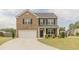 Charming two-story home with brick and vinyl siding, a well-manicured lawn, and a two-car garage at 3868 Sweet Iris Cir, Loganville, GA 30052