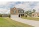 Inviting two-story home featuring a brick facade, well-manicured lawn, and a spacious driveway leading to a two-car garage at 3868 Sweet Iris Cir, Loganville, GA 30052