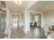 Open concept foyer with hardwood floors leading to dining and living areas, showcasing modern interior design at 3868 Sweet Iris Cir, Loganville, GA 30052