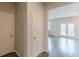 Hallway with doors and access to living space with large glass doors at 3868 Sweet Iris Cir, Loganville, GA 30052