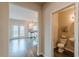 Hallway view showcasing the powder room and kitchen with backyard access at 3868 Sweet Iris Cir, Loganville, GA 30052