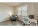 Bright home office featuring wood floors, a work desk and a cozy gray armchair at 3868 Sweet Iris Cir, Loganville, GA 30052