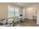 Bright office area with wood floors, desk, chair and large sunny window at 3868 Sweet Iris Cir, Loganville, GA 30052