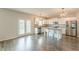 Open kitchen with stainless steel appliances, granite counters, kitchen island and hardwood style flooring at 3868 Sweet Iris Cir, Loganville, GA 30052