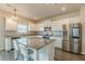 Bright kitchen features white cabinets, granite countertops, stainless steel appliances, and stylish chandelier at 3868 Sweet Iris Cir, Loganville, GA 30052