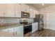 Well-equipped kitchen with white cabinets, granite counters, stainless steel appliances, and modern backsplash at 3868 Sweet Iris Cir, Loganville, GA 30052