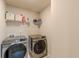 Laundry room featuring stainless steel washer and dryer at 3868 Sweet Iris Cir, Loganville, GA 30052