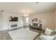 Comfortable living room featuring a fireplace, hardwood floors, and plenty of natural light at 3868 Sweet Iris Cir, Loganville, GA 30052