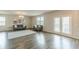 Bright living room with hardwood floors, neutral walls, and a sliding glass door at 3868 Sweet Iris Cir, Loganville, GA 30052