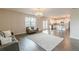 Open-concept living room leading to the kitchen features hardwood flooring and natural light at 3868 Sweet Iris Cir, Loganville, GA 30052
