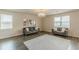 Spacious living room with hardwood floors, neutral walls, and large windows at 3868 Sweet Iris Cir, Loganville, GA 30052